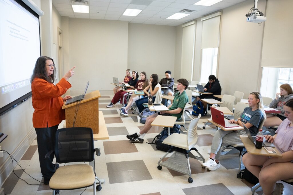 Photo of Nancy Locklin-Sofer at the head of a class