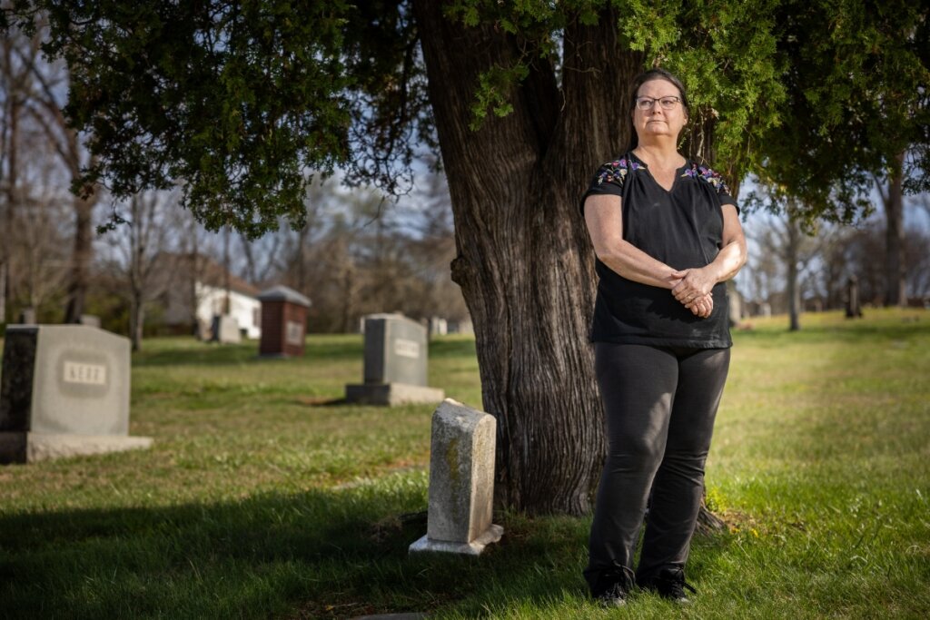 Photo of Maryville College professor Dr. Nancy Locklin-Sofer standing under a tree in a cemetery