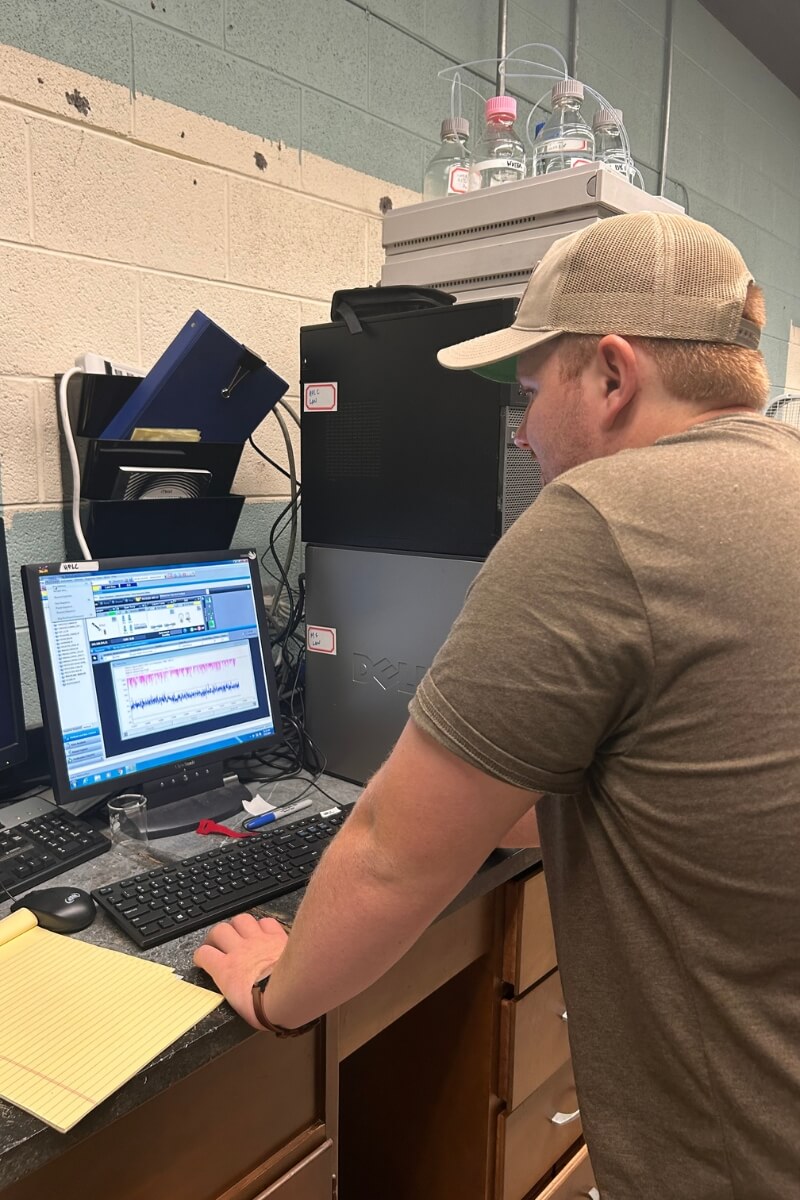 Photo of Colby Huffman looking at test results on a computer