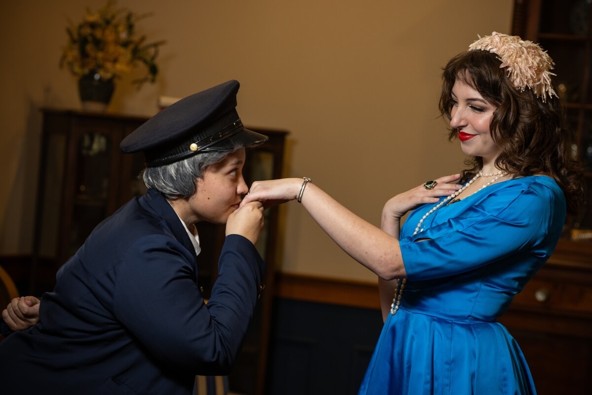 Photo of a Maryville College theater student kissing another theater student's hand