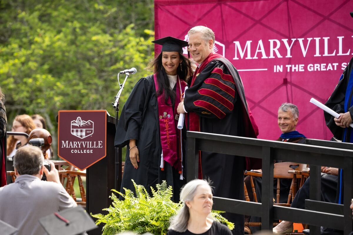 Photo of Rukhshona Isomova with Dr. Bryan Coker at Commencement 2026.