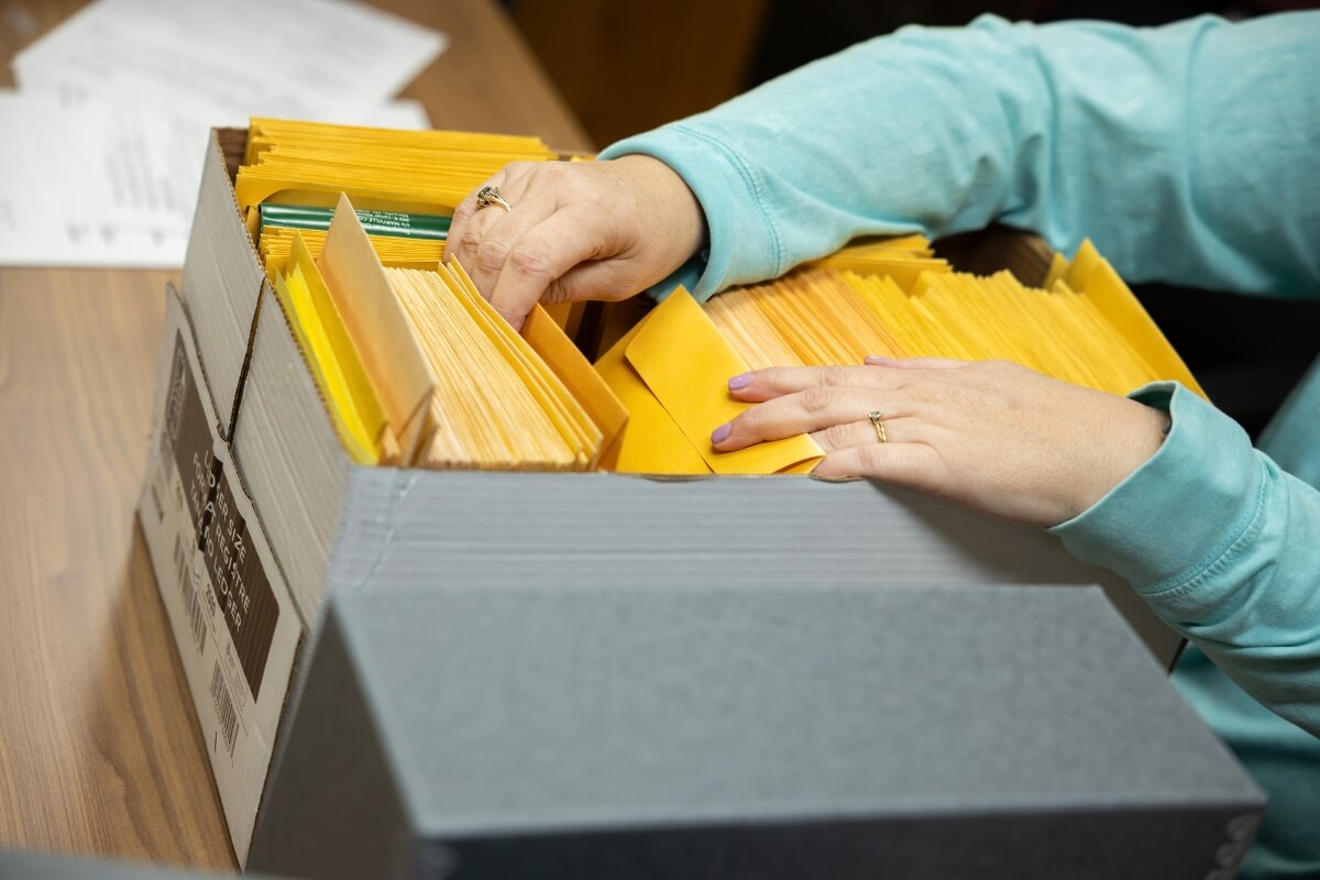 Photo of a woman going through a box of file folders