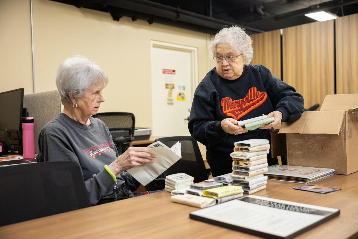 Photo of two volunteers in the Maryville College Archives space
