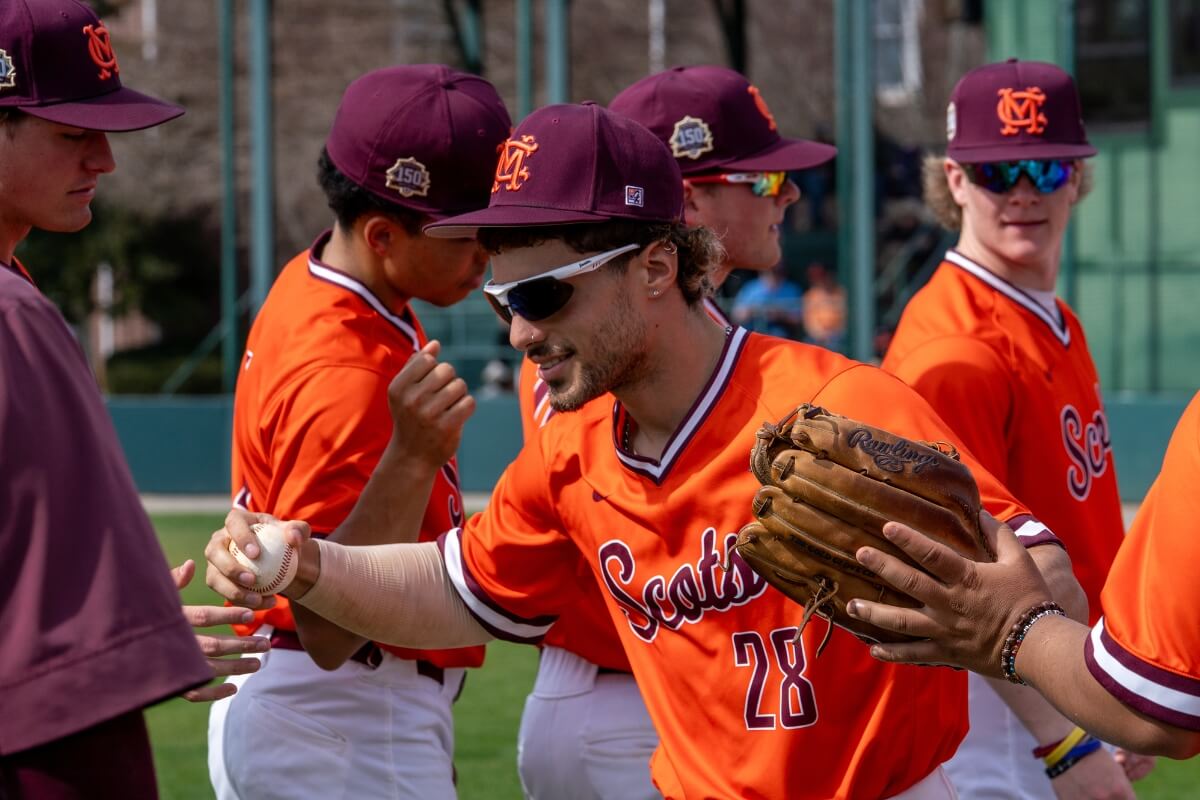 Photo of a baseball player congratulating fellow players