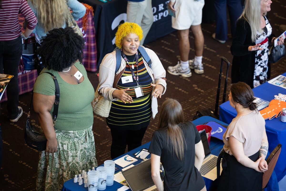 Photo of two women talking to a representative at the Maryville College Spring Opportunities Fair