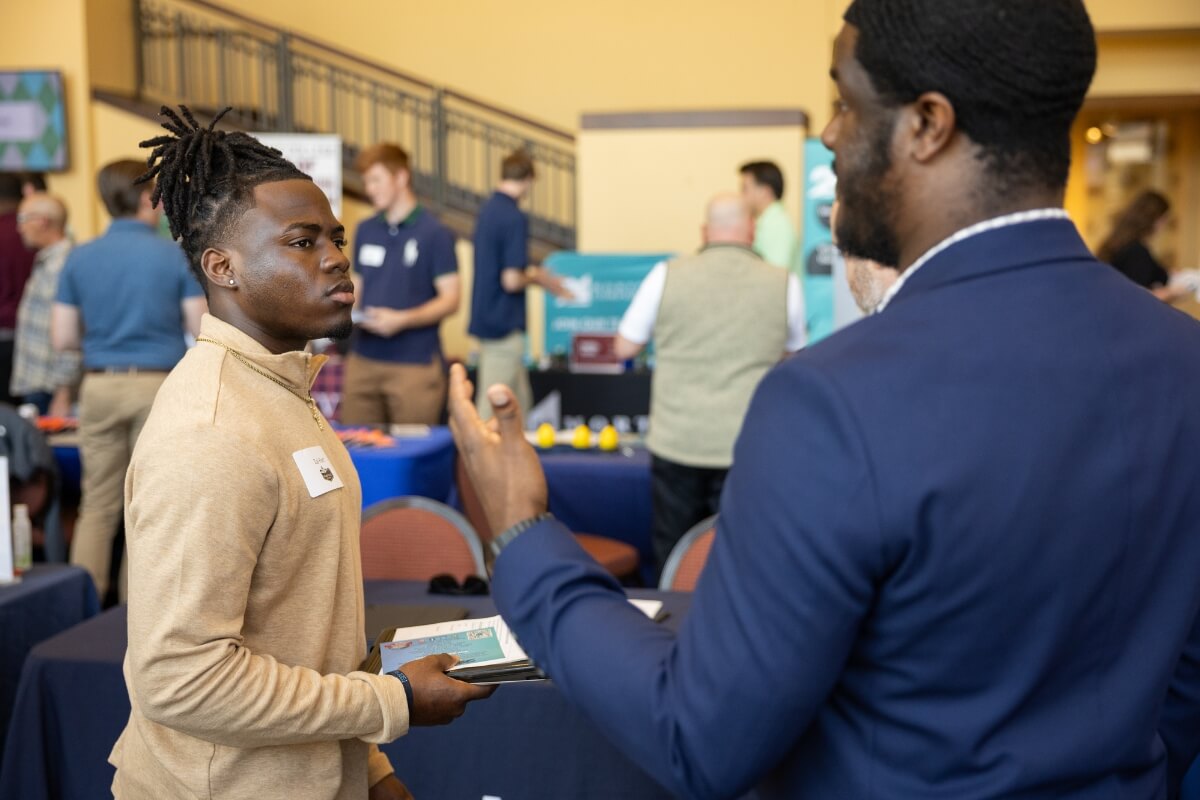 Photo of two Black men talking during the Maryville College Spring Opportunities Fair
