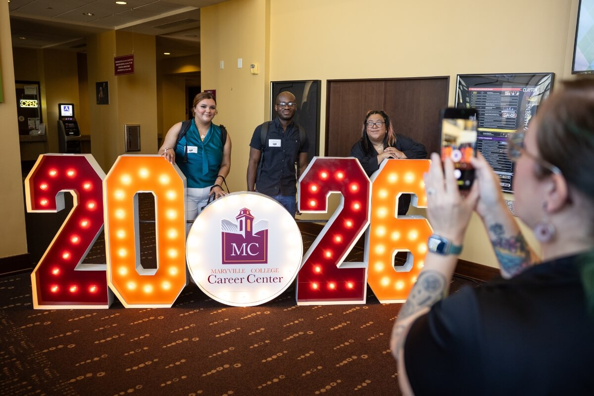 Photo of students posing with a 2026 sign