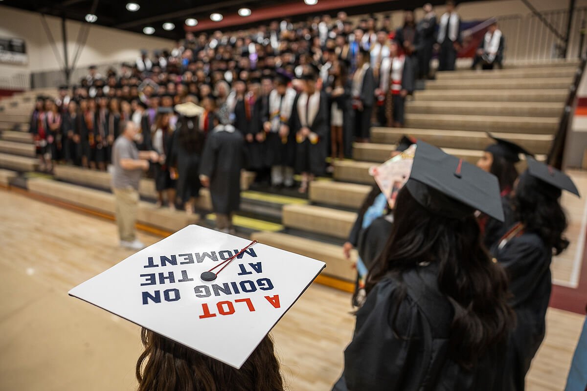 Photo of a group of seniors preparing for Maryville College graduation in a gym