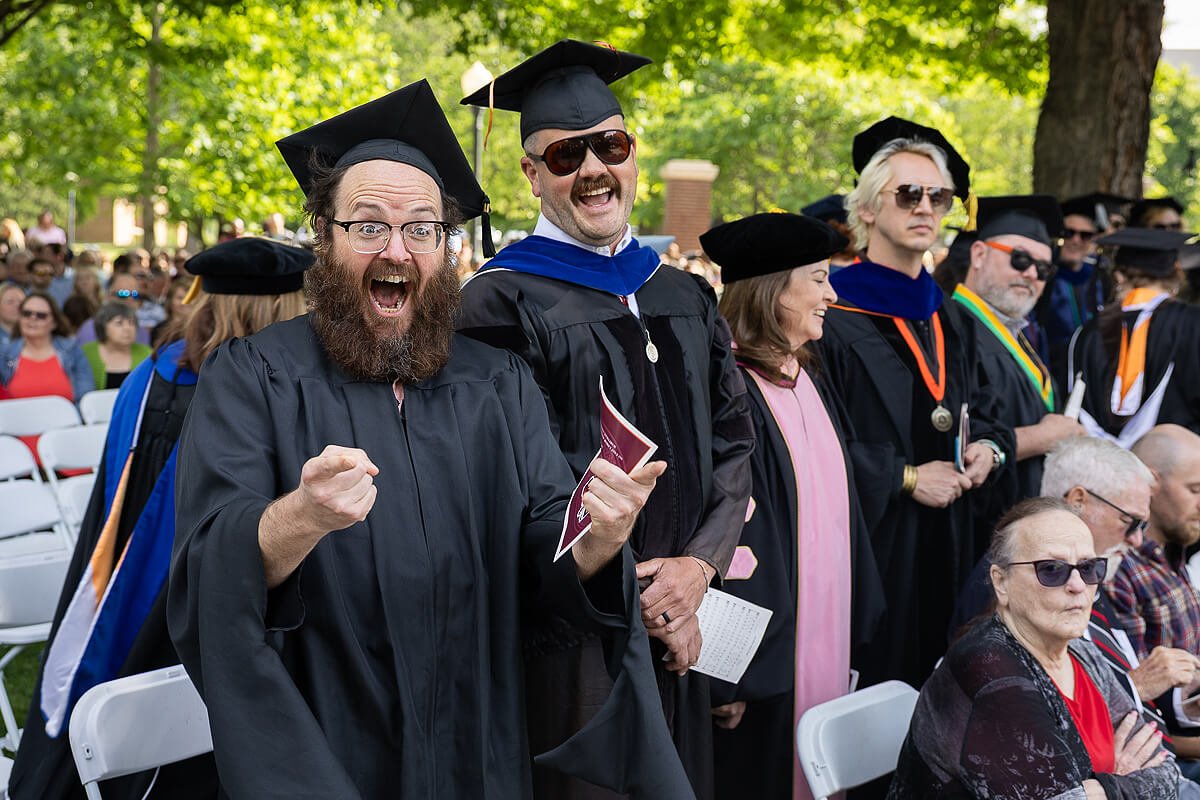 Photo of two excited members of the Maryville College faculty at the 2026 graduation