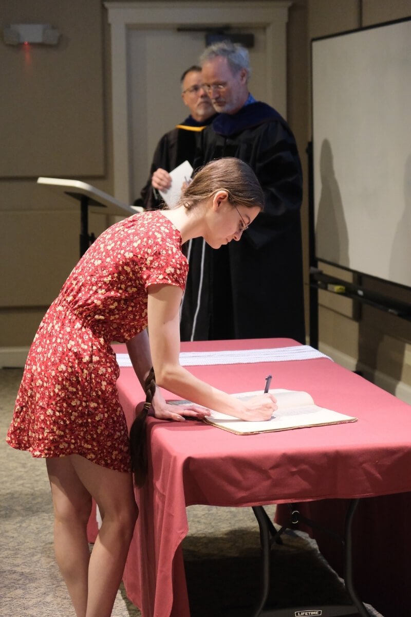 Photo of a new Maryville College honor society member signing their name