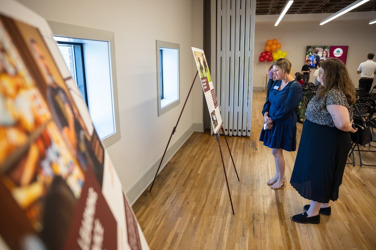 Photo of two women looking at posterboard presentation at Maryville College's April 13 Carnegie Classification celebration