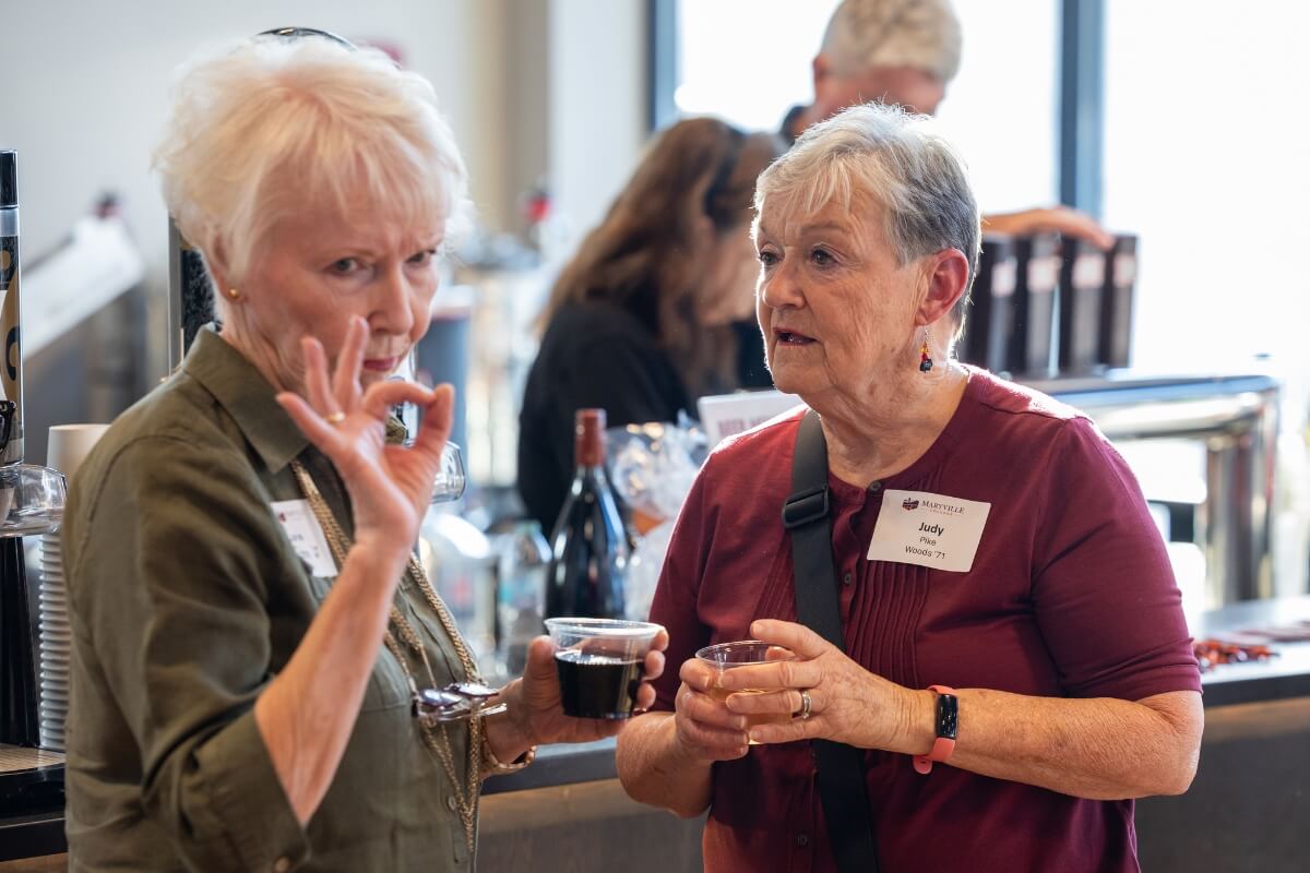 Photo of two older women talking to one another