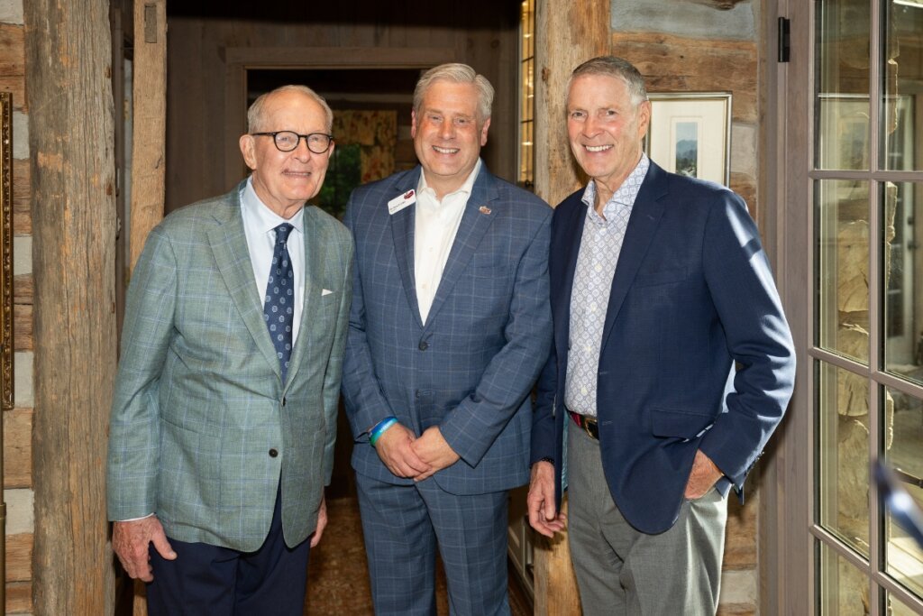 Photo of three important men smiling at the camera