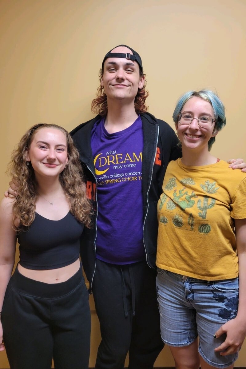 Photo of three people standing and smiling because they're new members of one of Maryville College's honor societies