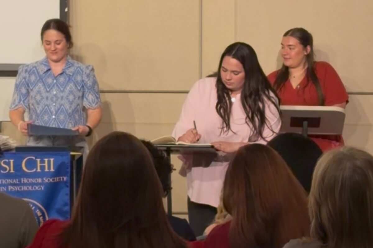 Photo of a woman signing a piece of paper