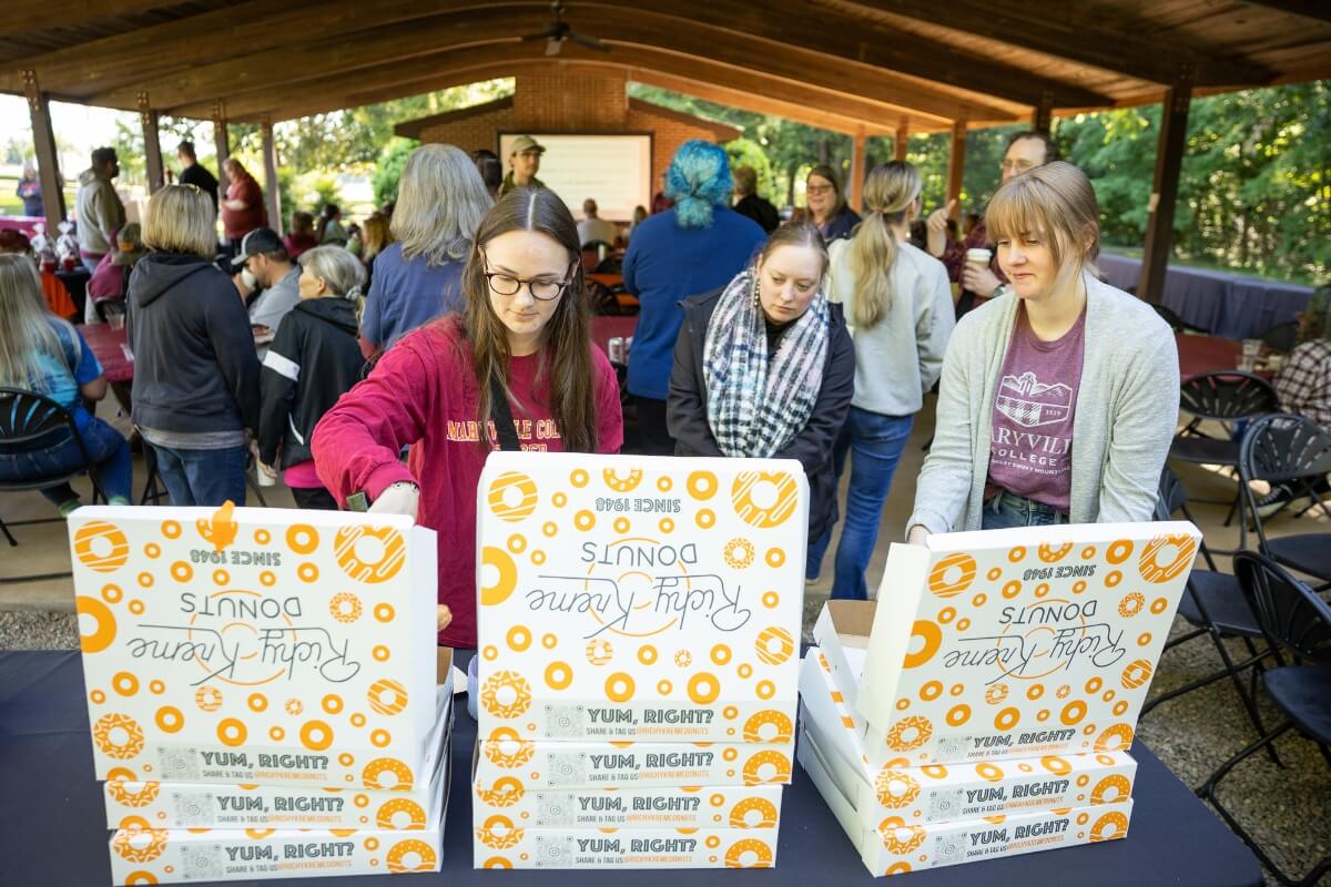 Photo of people getting donuts