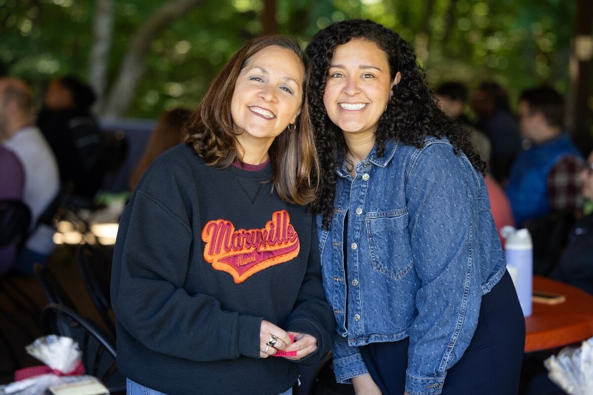Photo of two amazing women smiling at the camera
